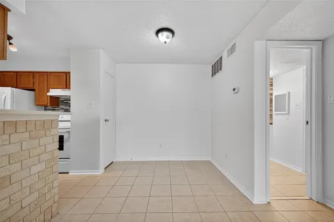 a view of kitchen with white cabinets