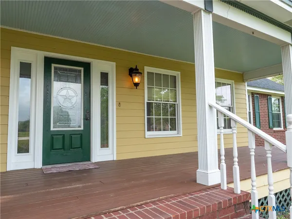 an aerial view of house with yard and outdoor seating