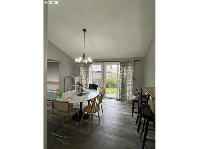 a kitchen with a table chairs stove and cabinets