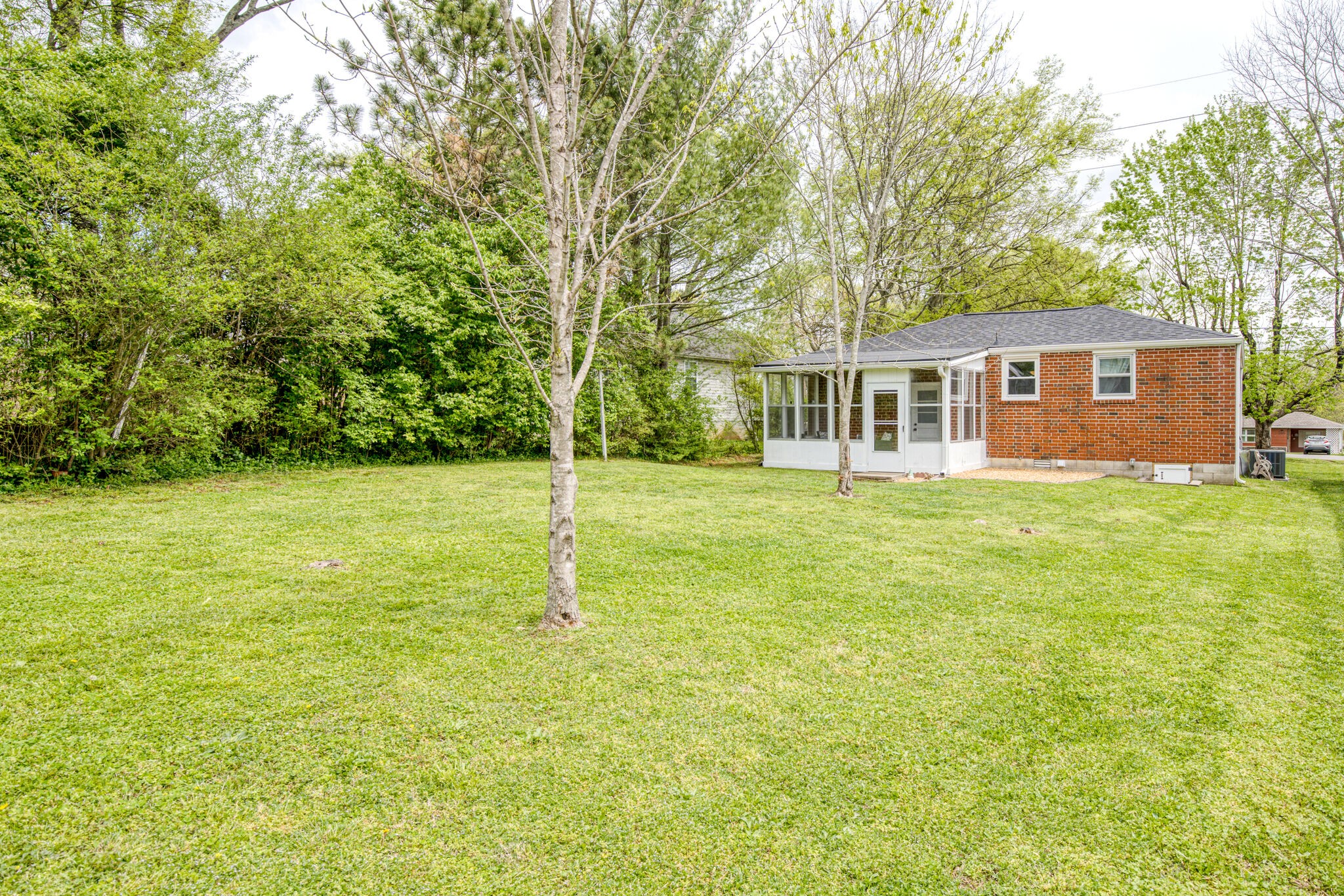 236 Forest Park Road Madison, TN 37115 - Photo 22 of 23 a backyard of a house with lots of green space and garden view