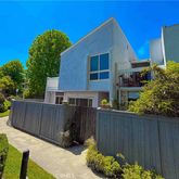 a view of a house with wooden fence