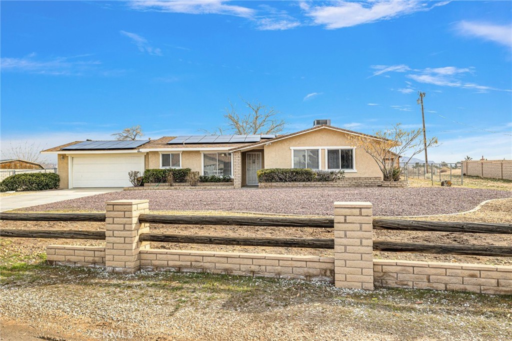 13787 Cree Road Apple Valley, CA 92307 - Photo 1 of 1 a front view of a house with a yard