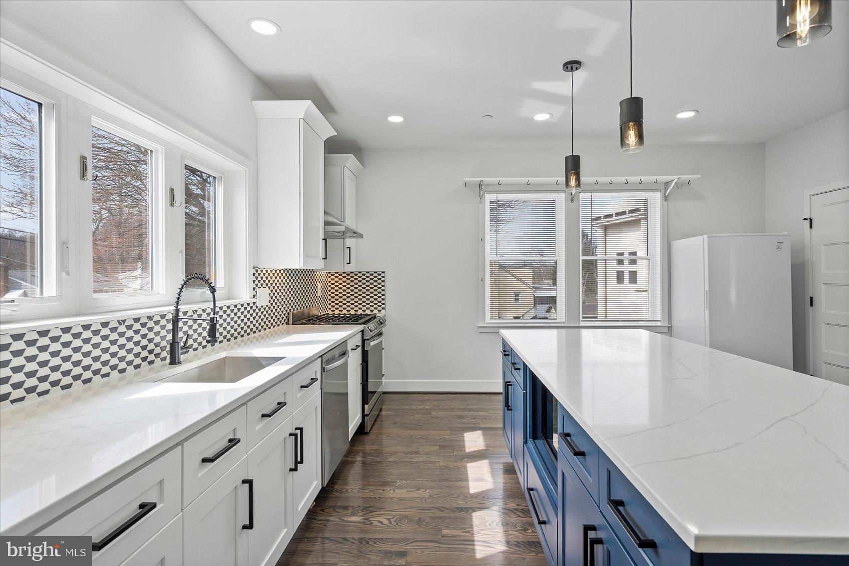 11030 Bird River Grove Road White Marsh, MD 21162 - Photo 22 of 53 a large white kitchen with a large window