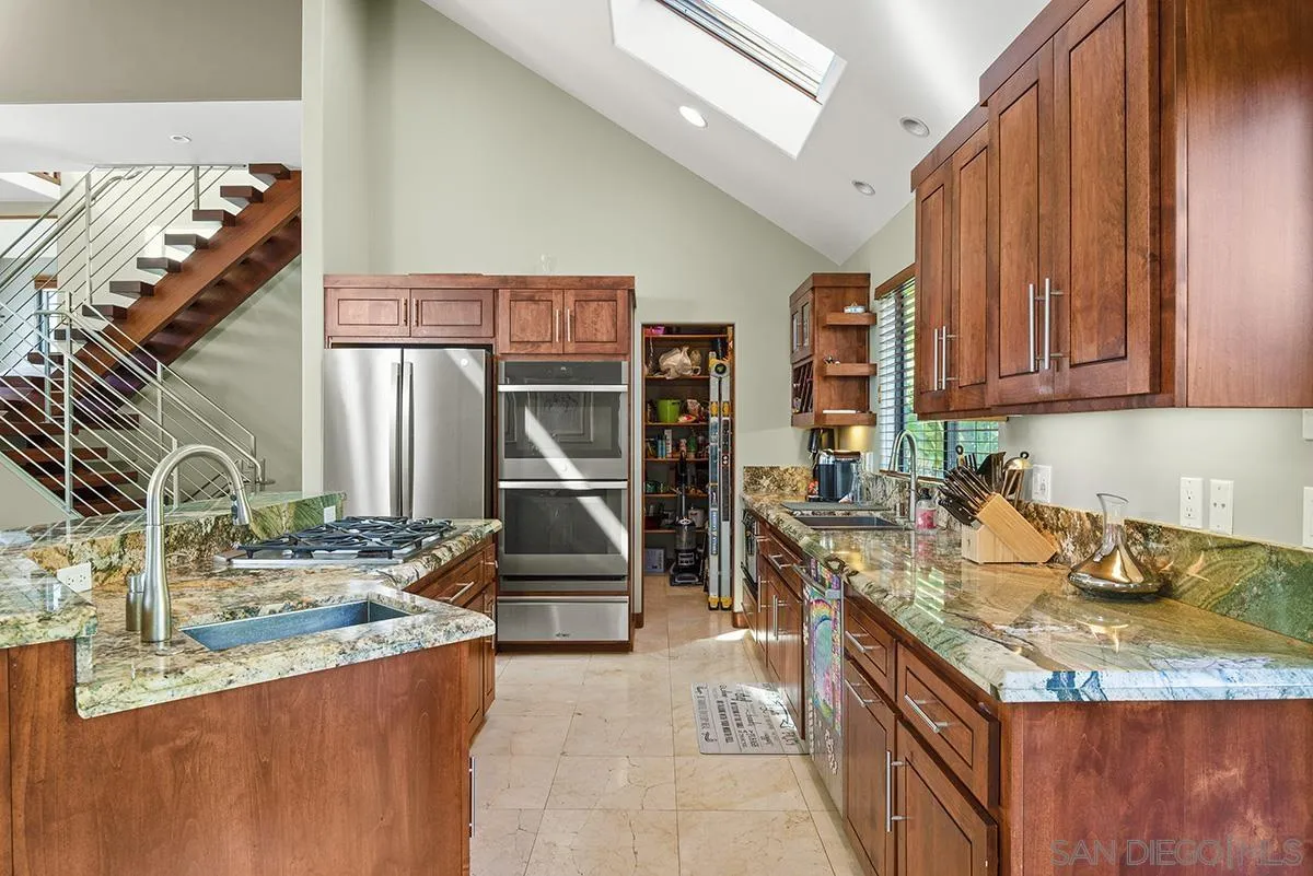 13613 Mar Scenic Drive Del Mar, CA 92014 - Photo 17 of 46 a kitchen with granite countertop a sink and a stove top oven