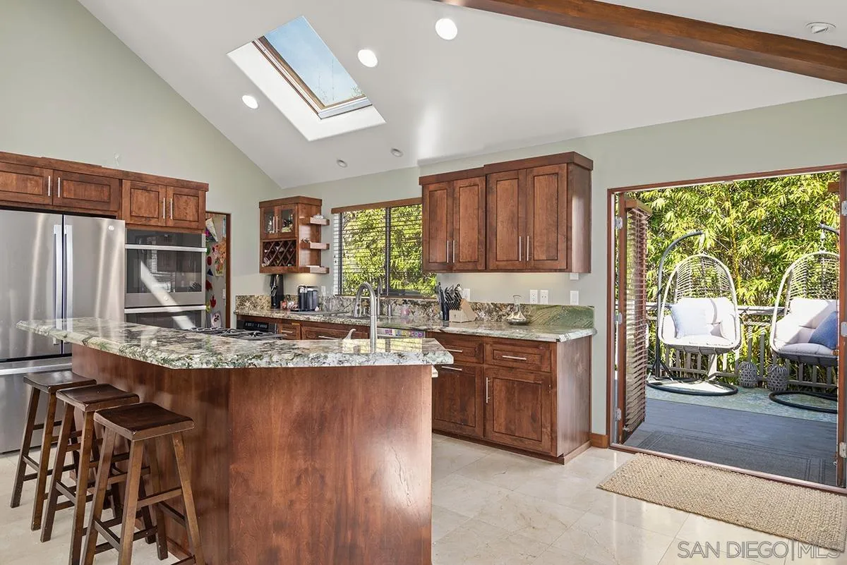 13613 Mar Scenic Drive Del Mar, CA 92014 - Photo 18 of 46 a kitchen with stainless steel appliances granite countertop a stove a sink and a refrigerator