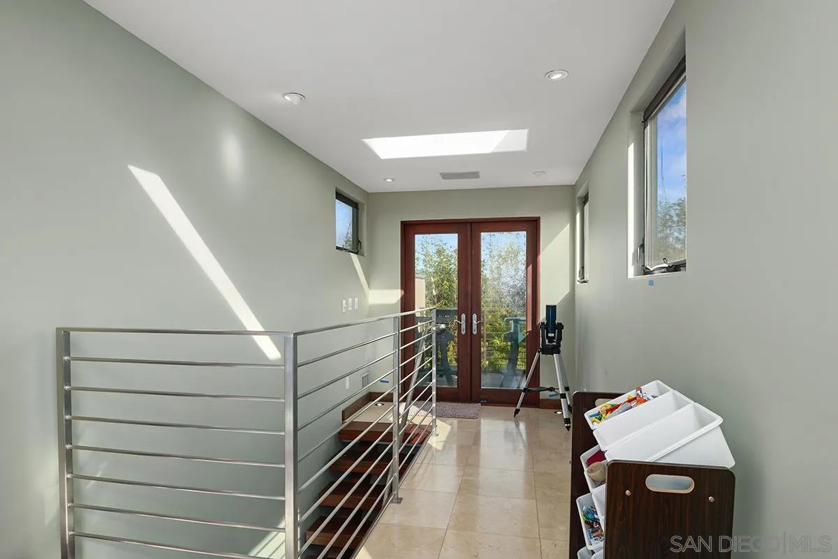 13613 Mar Scenic Drive Del Mar, CA 92014 - Photo 34 of 46 a hallway with a white stove top oven and furniture