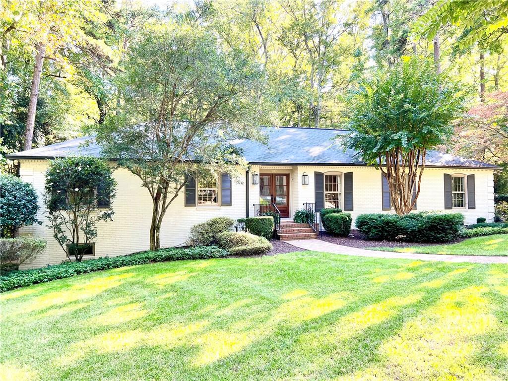 a front view of house with yard and green space