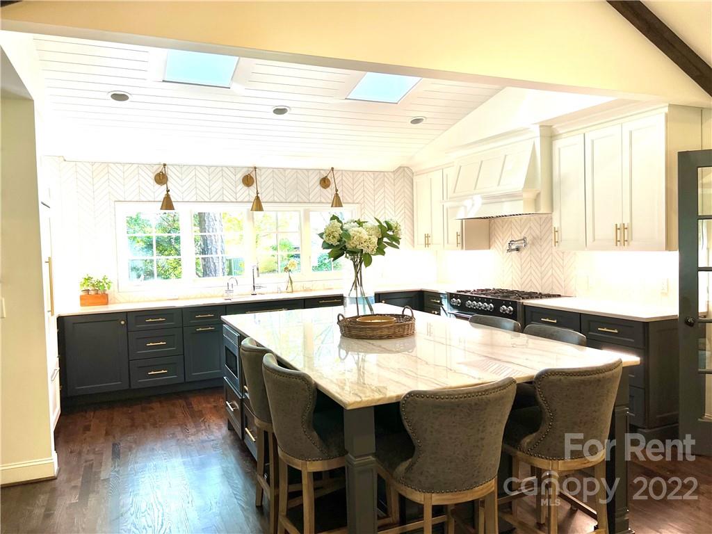 207 Crescent Drive Davidson, NC 28036 - Photo 2 of 3 a kitchen with a table chairs stove and cabinets