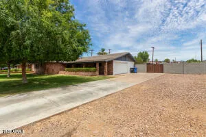 a front view of a house with a yard and road