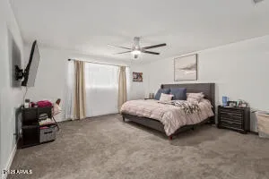 a bedroom with a bed and a tv