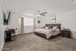 9001 North 13th Avenue Phoenix, AZ 85021 - Photo 12 of 25 a bedroom with a bed and a tv