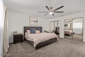 a spacious bedroom with a bed and ceiling fan