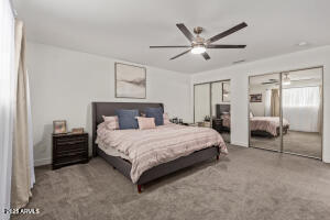 9001 North 13th Avenue Phoenix, AZ 85021 - Photo 14 of 25 a spacious bedroom with a bed and ceiling fan