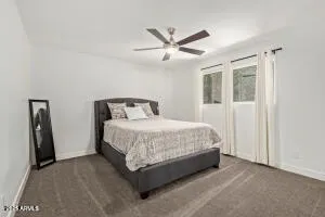 a bedroom with a bed and ceiling fan