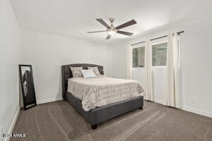 9001 North 13th Avenue Phoenix, AZ 85021 - Photo 18 of 25 a bedroom with a bed and ceiling fan