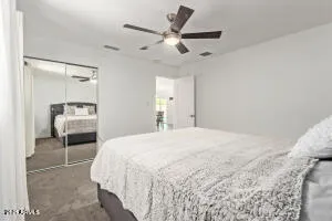 a bedroom with a bed and a large mirror