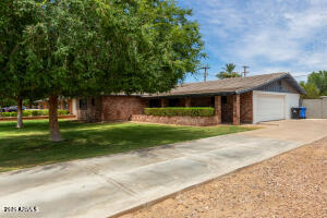 9001 North 13th Avenue Phoenix, AZ 85021 - Photo 2 of 25 a front view of a house with a yard
