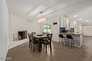 9001 North 13th Avenue Phoenix, AZ 85021 - Photo 7 of 25 a view of a dining room with furniture and chandelier