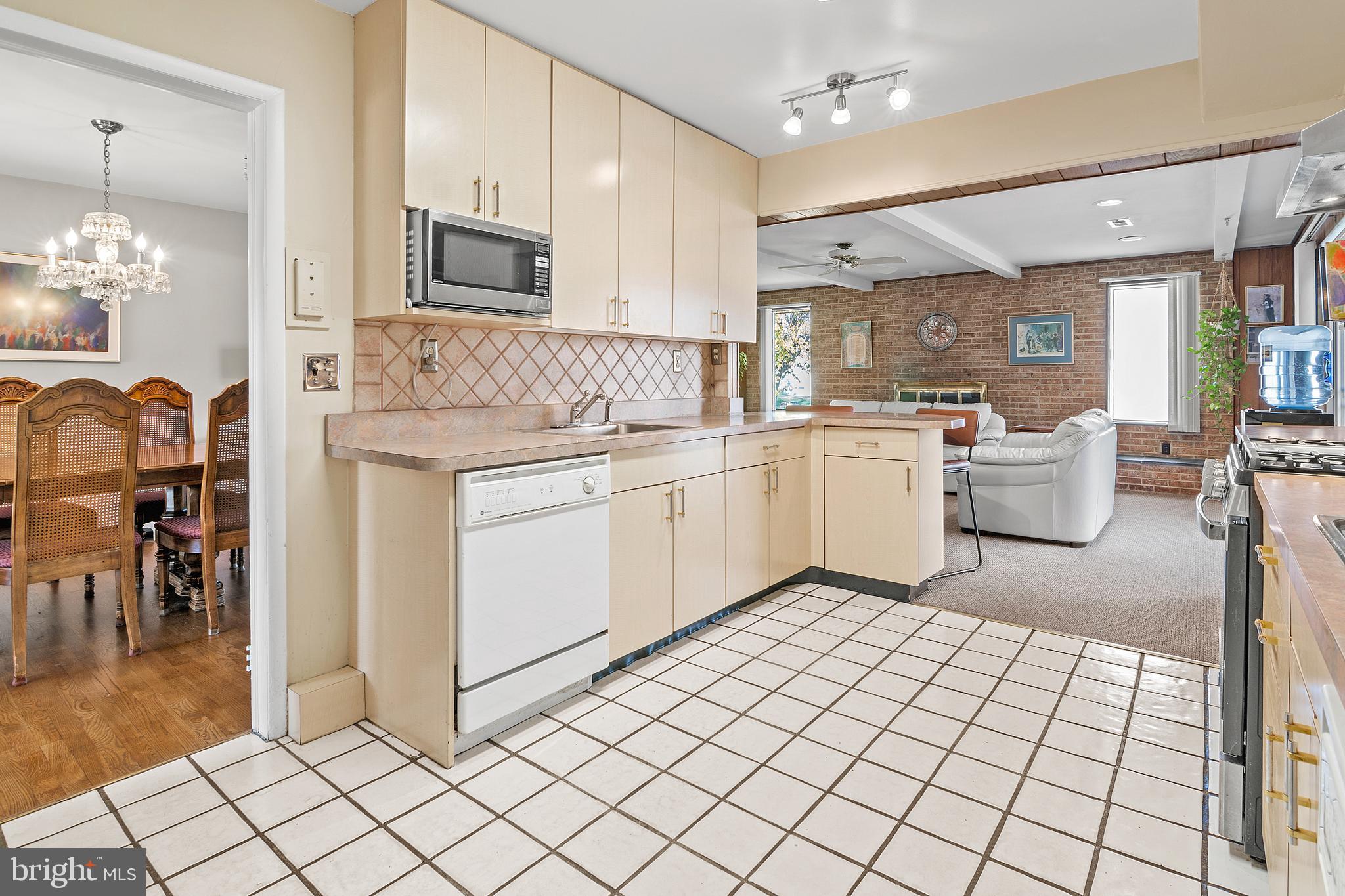 6311 Ivymount Road Baltimore, MD 21209 - Photo 8 of 23 a large white kitchen with a sink and cabinets