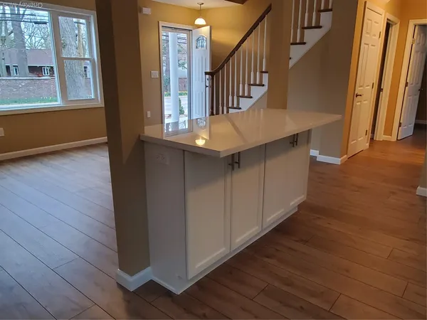 a view of entryway and hall with wooden floor