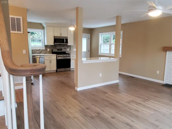 a kitchen with granite countertop a stove a sink and a refrigerator