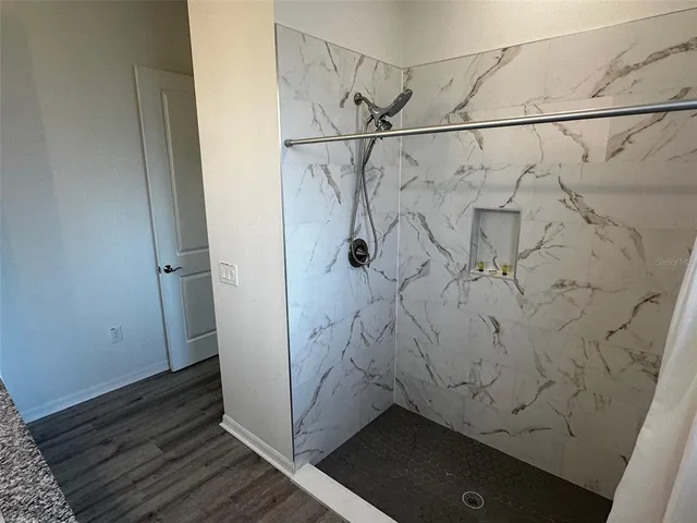 a bedroom with a bed and a desk next to a window