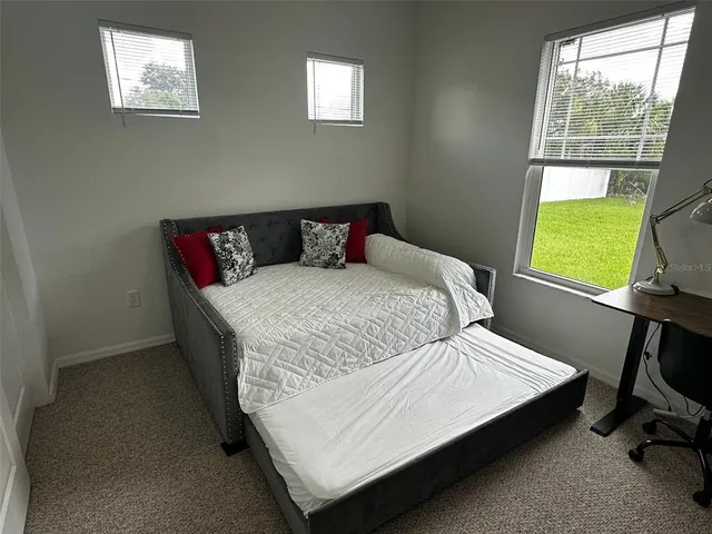 a view of a room with a table and chairs