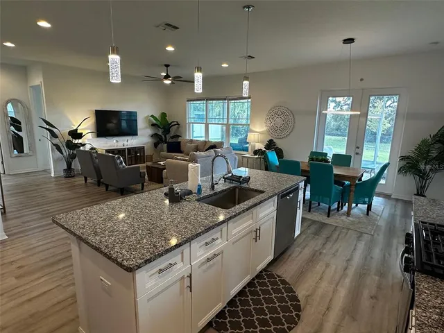 a large kitchen with lots of counter space and windows