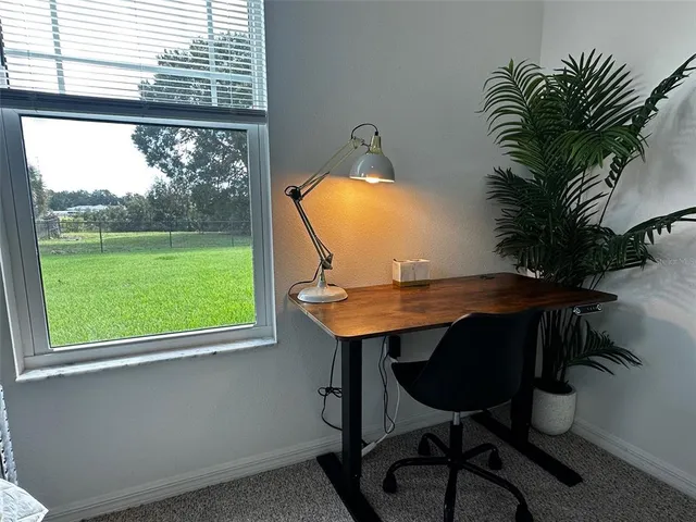 a bathroom with a granite countertop sink mirror vanity and toilet