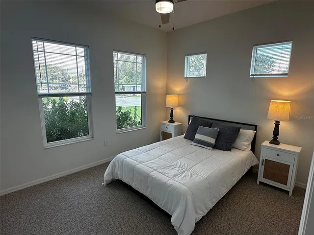 a bathroom with a granite countertop toilet sink and mirror