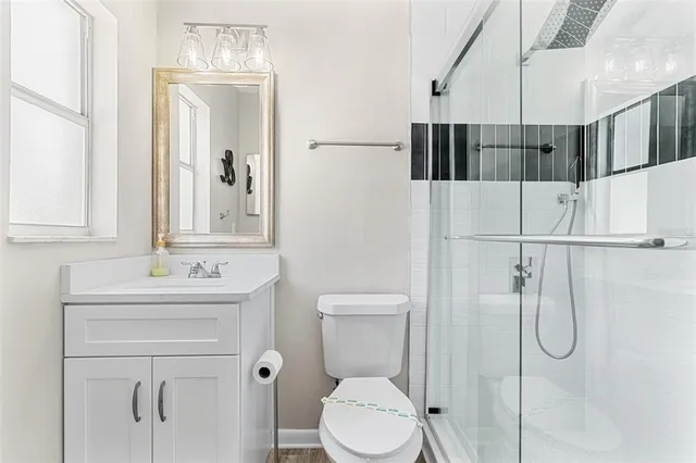 a bathroom with a toilet sink and shower