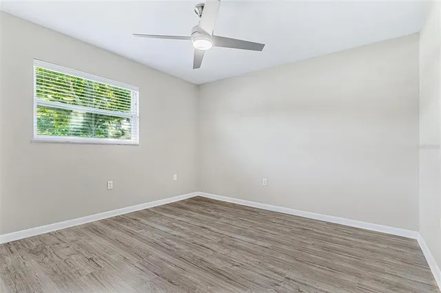 wooden floor in an empty room with a window