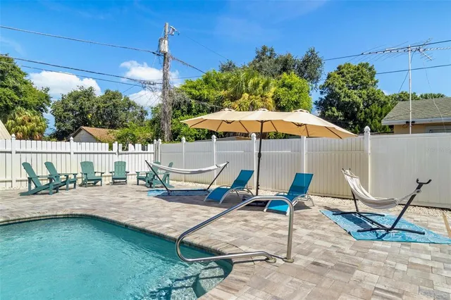 a backyard of a house with barbeque oven table and chairs