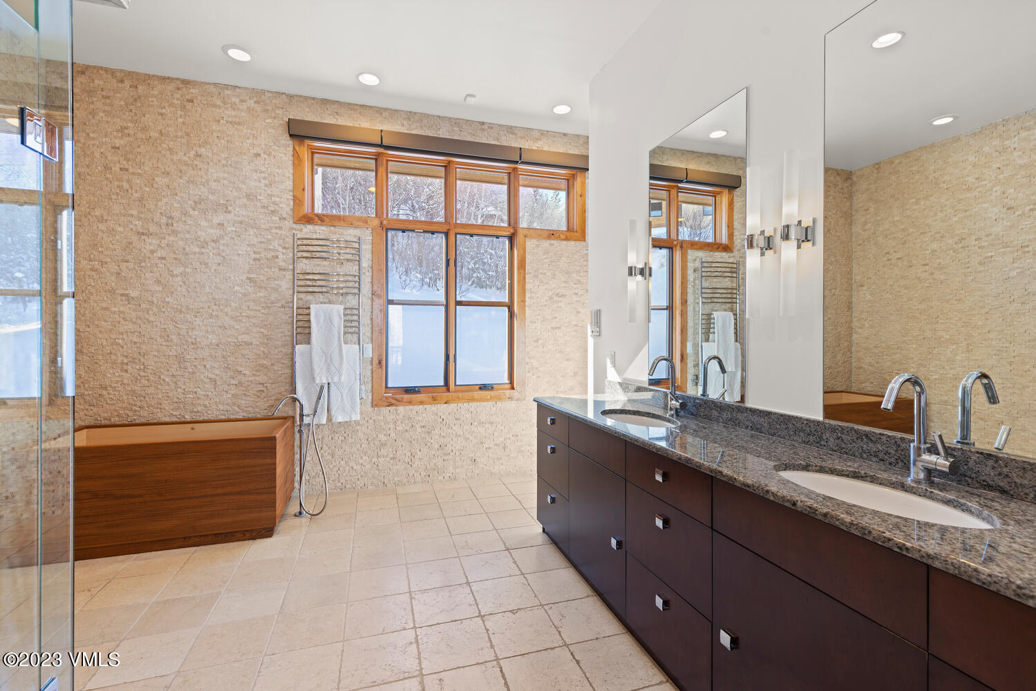 589 Eagle Drive Eagle-Vail, CO 81620 - Photo 12 of 33 a spacious bathroom with a granite countertop double vanity sink a mirror and a bathtub
