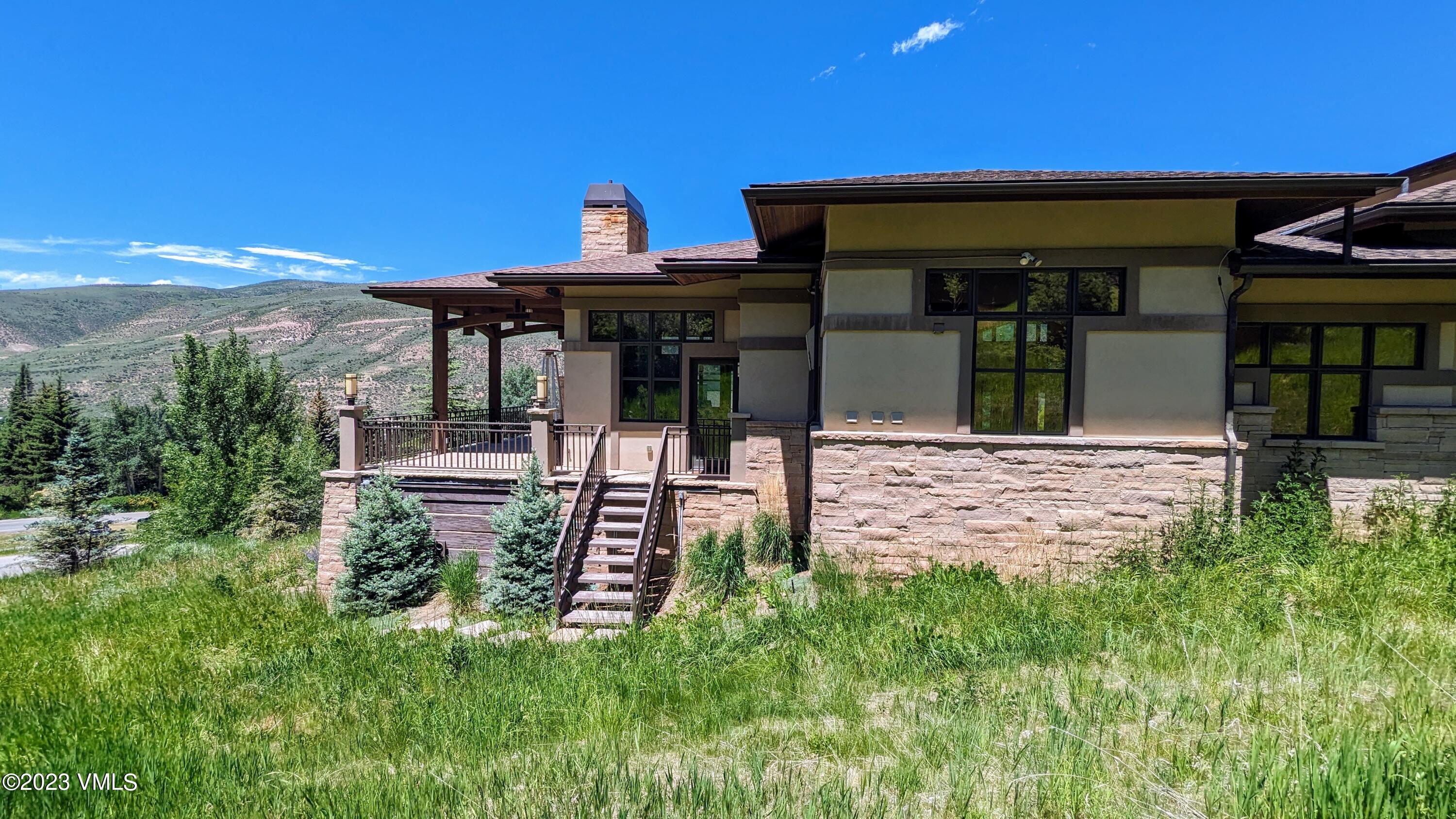 589 Eagle Drive Eagle-Vail, CO 81620 - Photo 31 of 33 a view of a house with floor to ceiling windows and a table