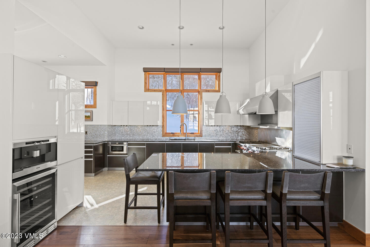 589 Eagle Drive Eagle-Vail, CO 81620 - Photo 7 of 33 a kitchen with a table chairs stove and cabinets