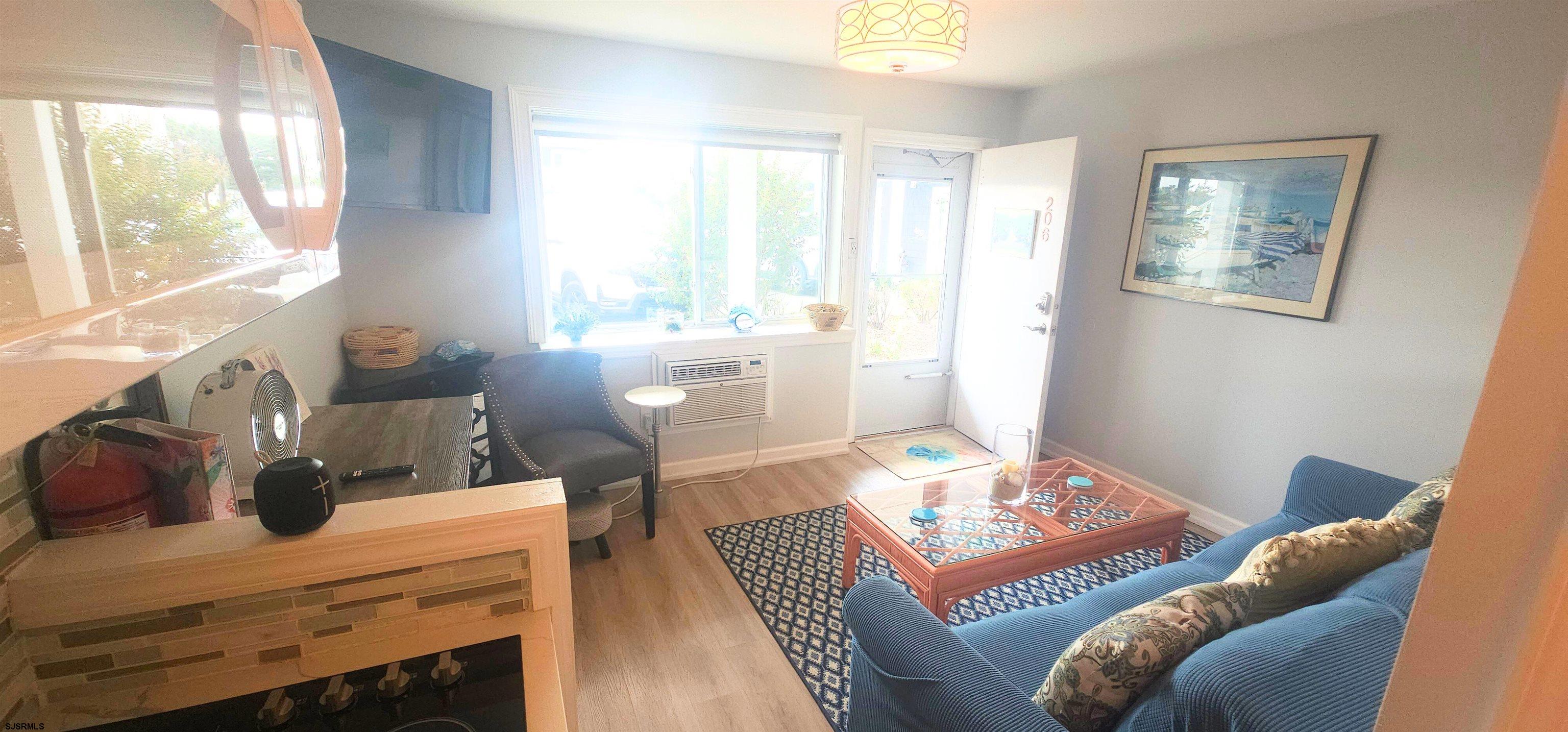 212 West Brigantine Avenue, Unit 206 Brigantine, NJ 08203 - Photo 3 of 8 a bedroom with a bed and wooden floor