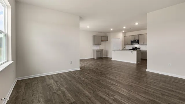 a view of kitchen with wooden floor and electronic appliances