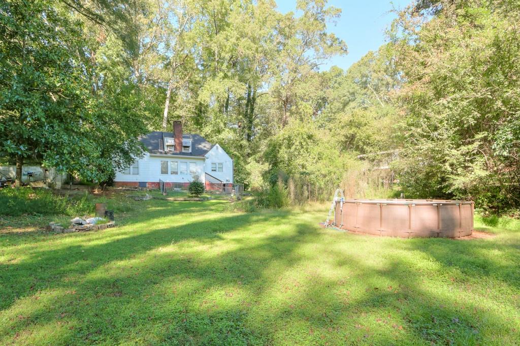 819 Northern Avenue Clarkston, GA 30021 - Photo 4 of 21 a view of a big yard with large trees