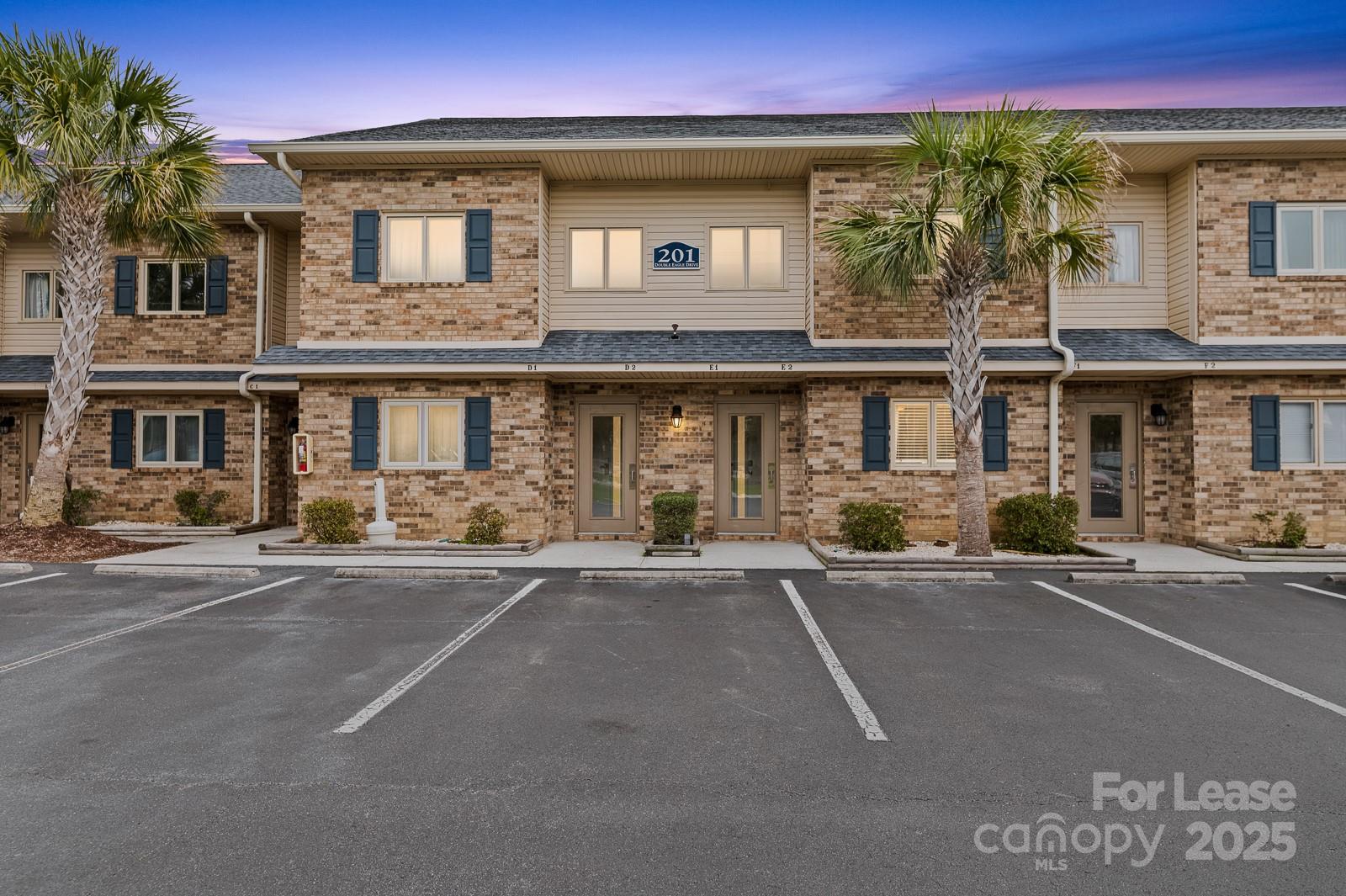 201 Double Eagle Drive, Unit E1 Surfside Beach, SC 29575 - Photo 1 of 19 front view of a building with a street
