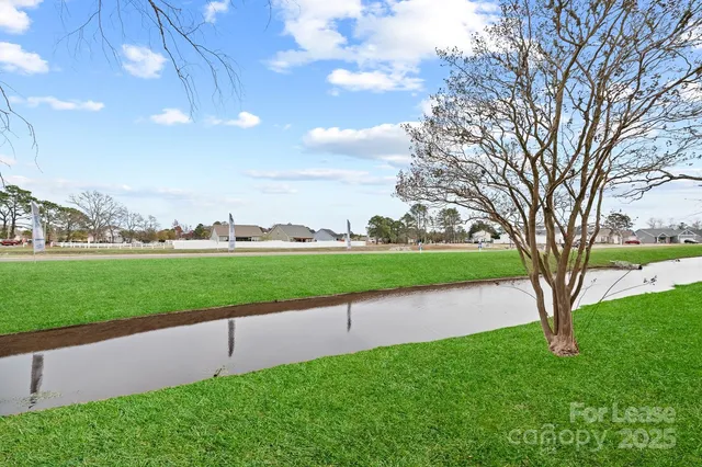 a view of a golf course with a lake view