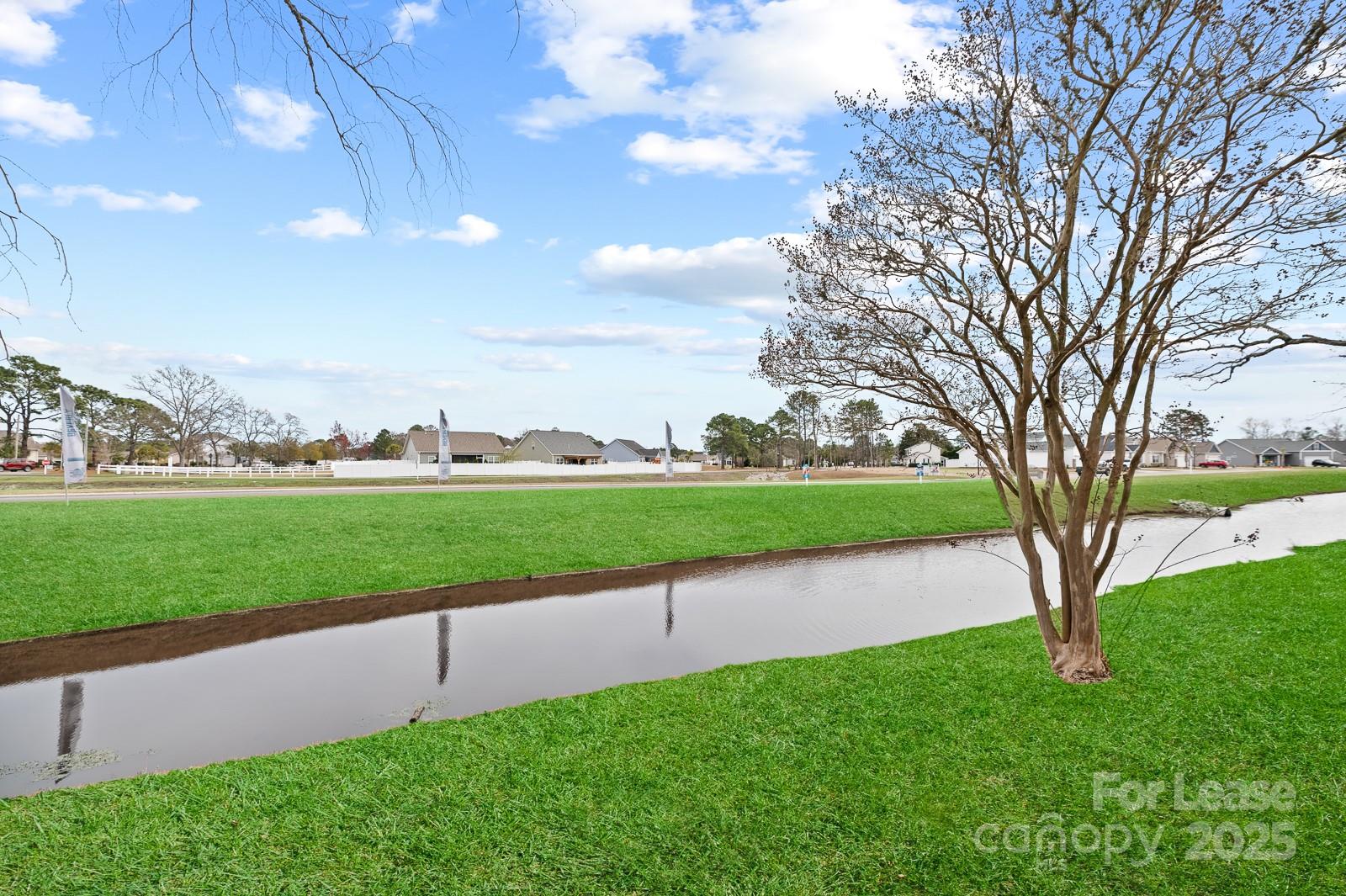 201 Double Eagle Drive, Unit E1 Surfside Beach, SC 29575 - Photo 16 of 19 a view of a golf course with a lake view