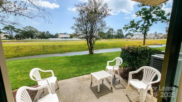 a view of a chair and table on the garden