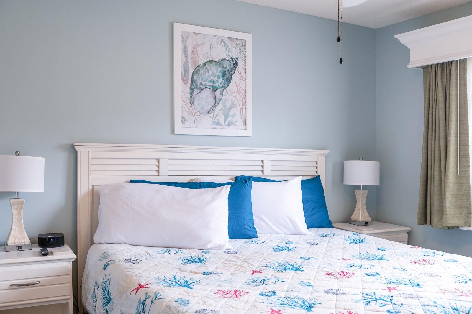 201 Double Eagle Drive, Unit E1 Surfside Beach, SC 29575 - Photo 3 of 19 a bedroom with a bed and painting on the wall