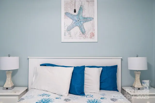 a bedroom with a bed and a lamp on table