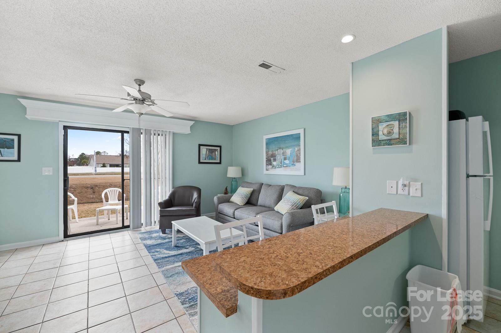201 Double Eagle Drive, Unit E1 Surfside Beach, SC 29575 - Photo 9 of 19 a living room with furniture and a table