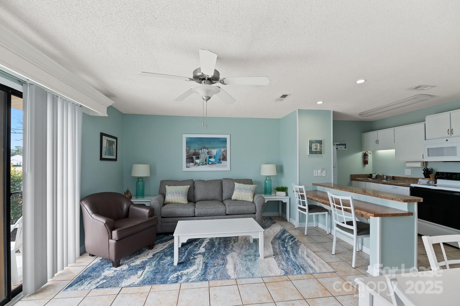 201 Double Eagle Drive, Unit E1 Surfside Beach, SC 29575 - Photo 10 of 19 a living room with furniture a rug and a window