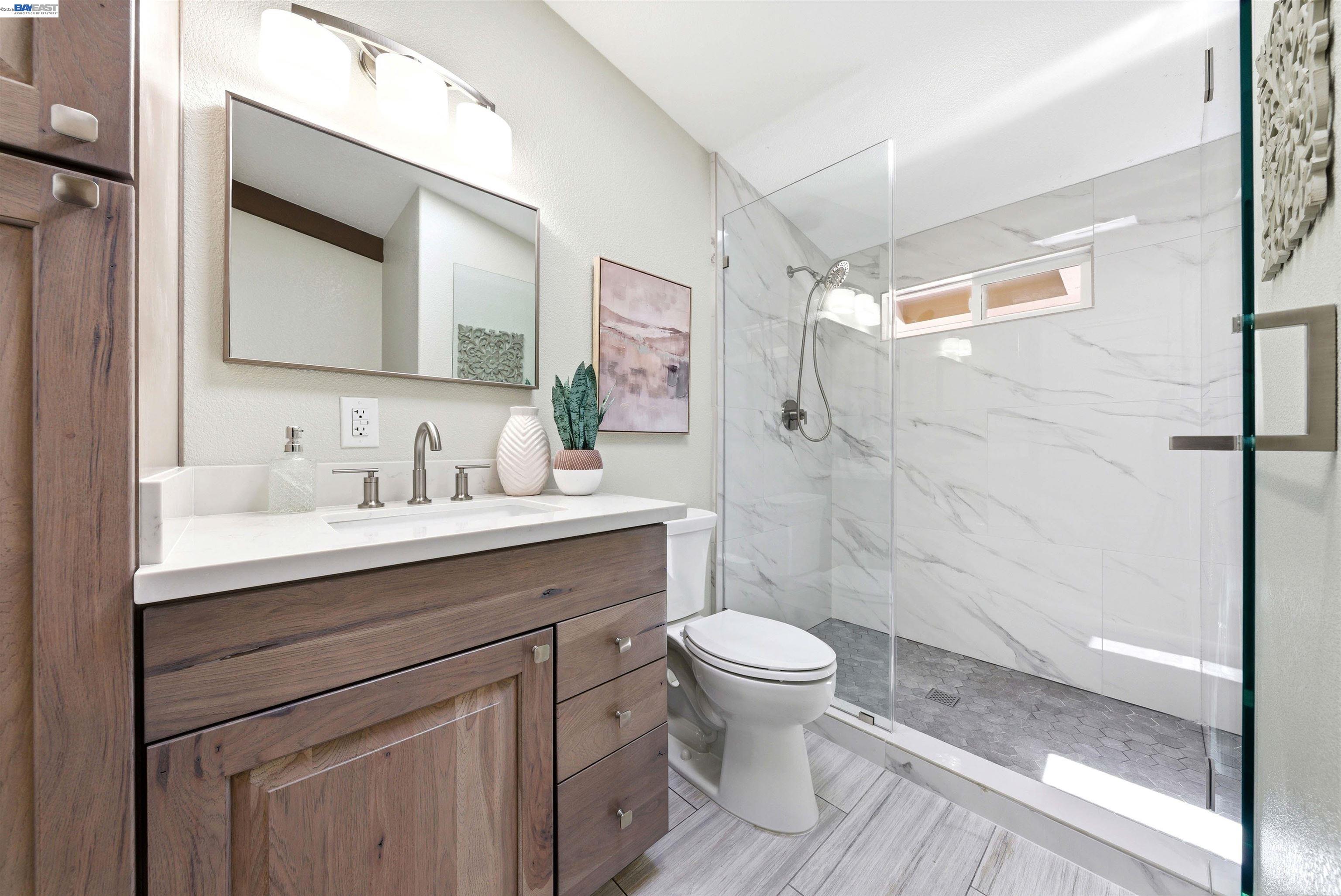 1929 Kilkare Road Sunol, CA 94586 - Photo 15 of 24 a bathroom with a sink a toilet a mirror and shower