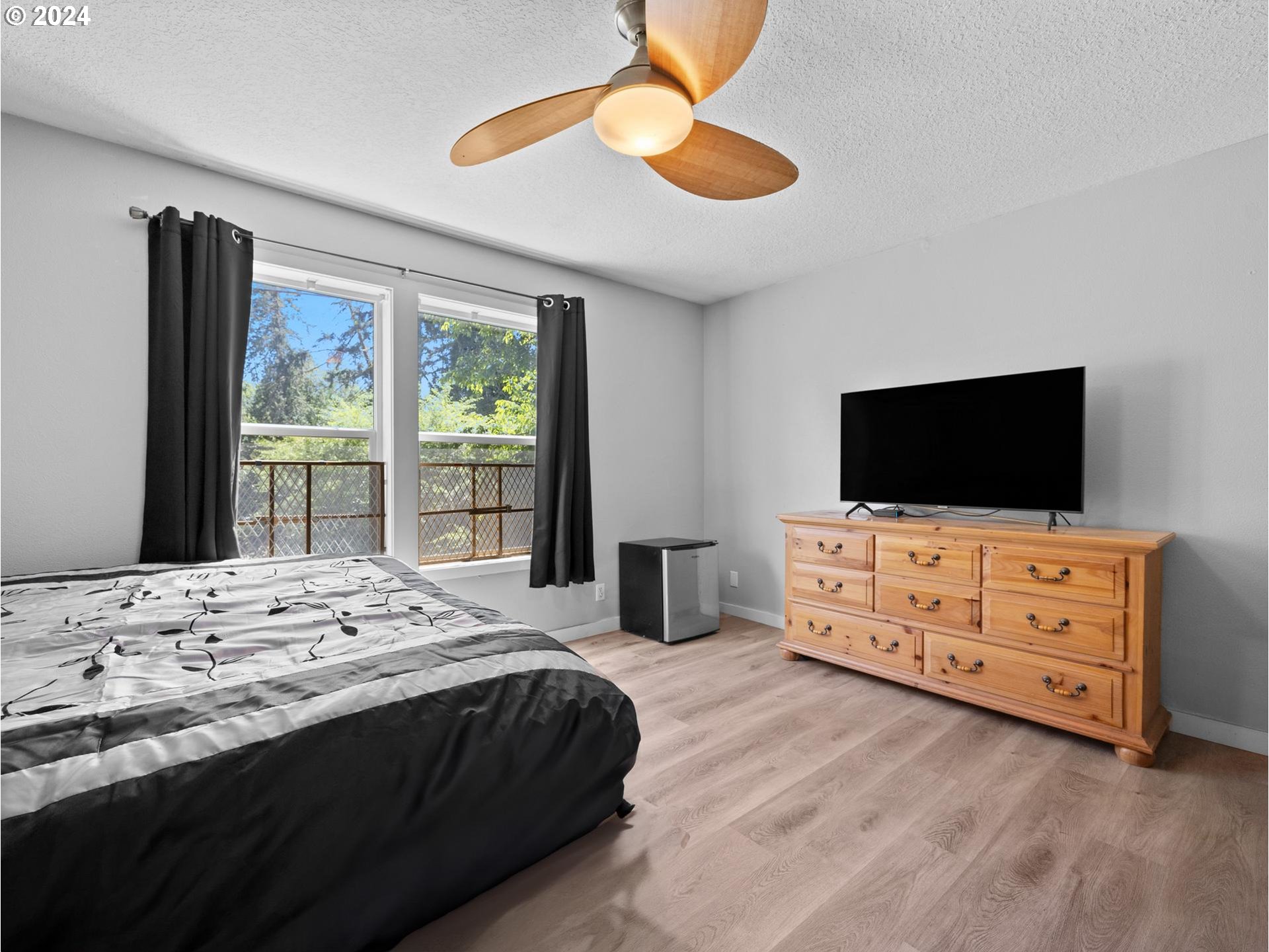 32980 Southwest Firdale Road Cornelius, OR 97113 - Photo 12 of 48 a bedroom with a bed and flat screen tv