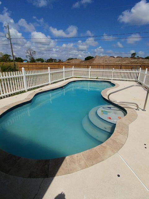 925 Southeast Albatross Avenue Port St. Lucie, FL 34983 - Photo 2 of 7 a view of a swimming pool with a seating area